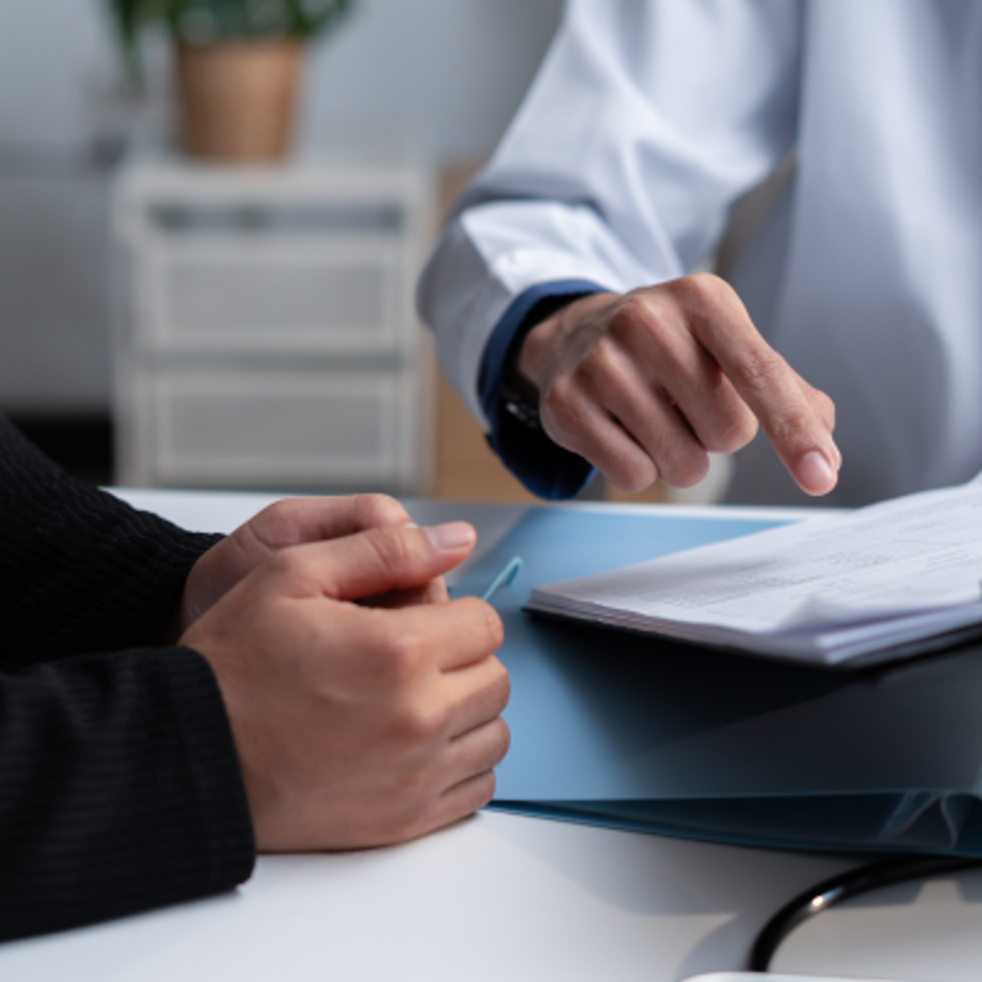 Two people sat looking over a folder of files