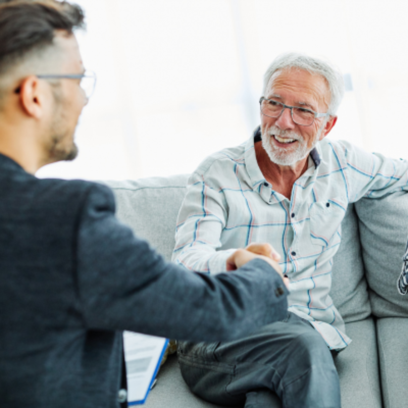 A senior man having a conversation with another man