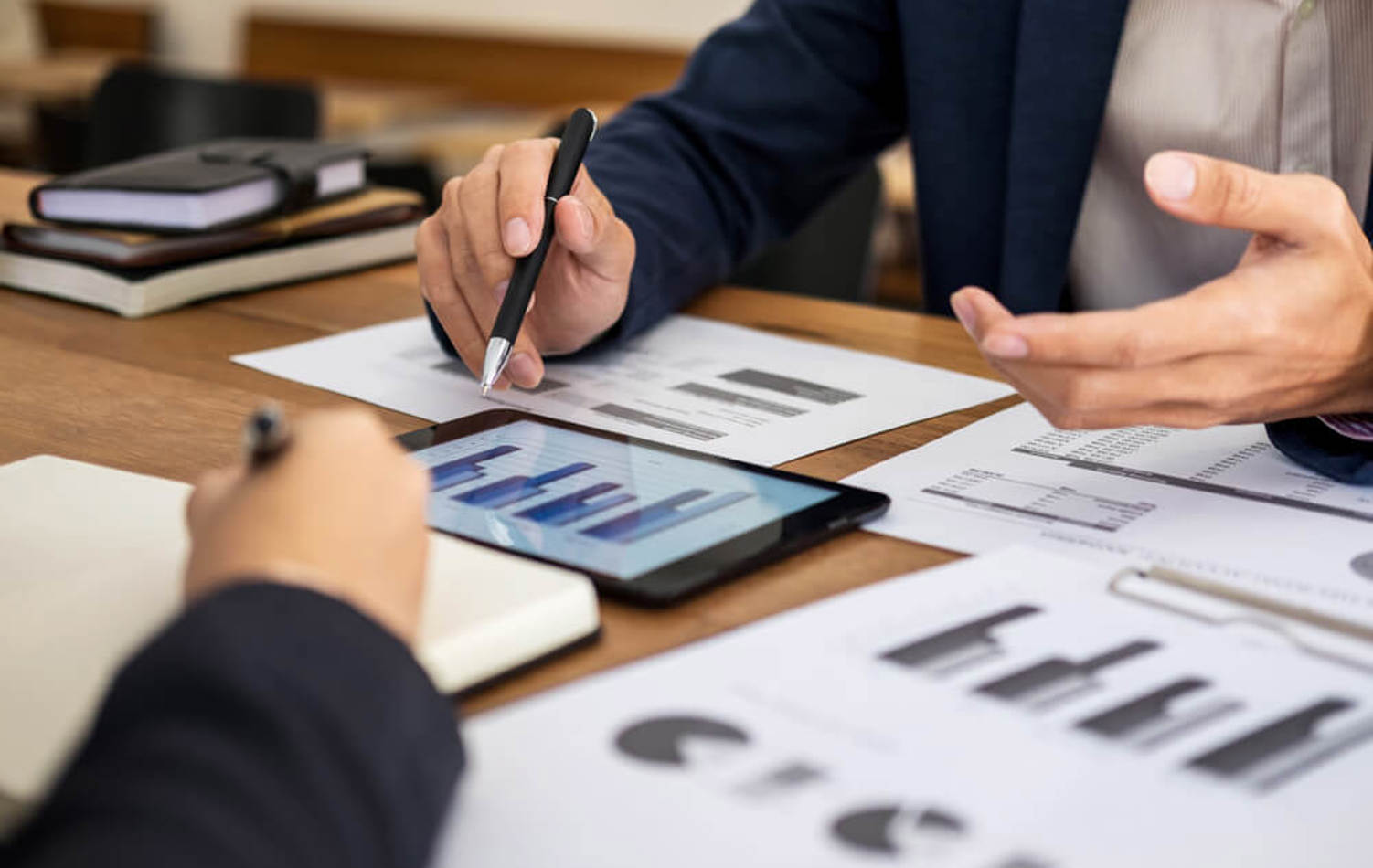 Two people looking over a set of fluctuating graphs