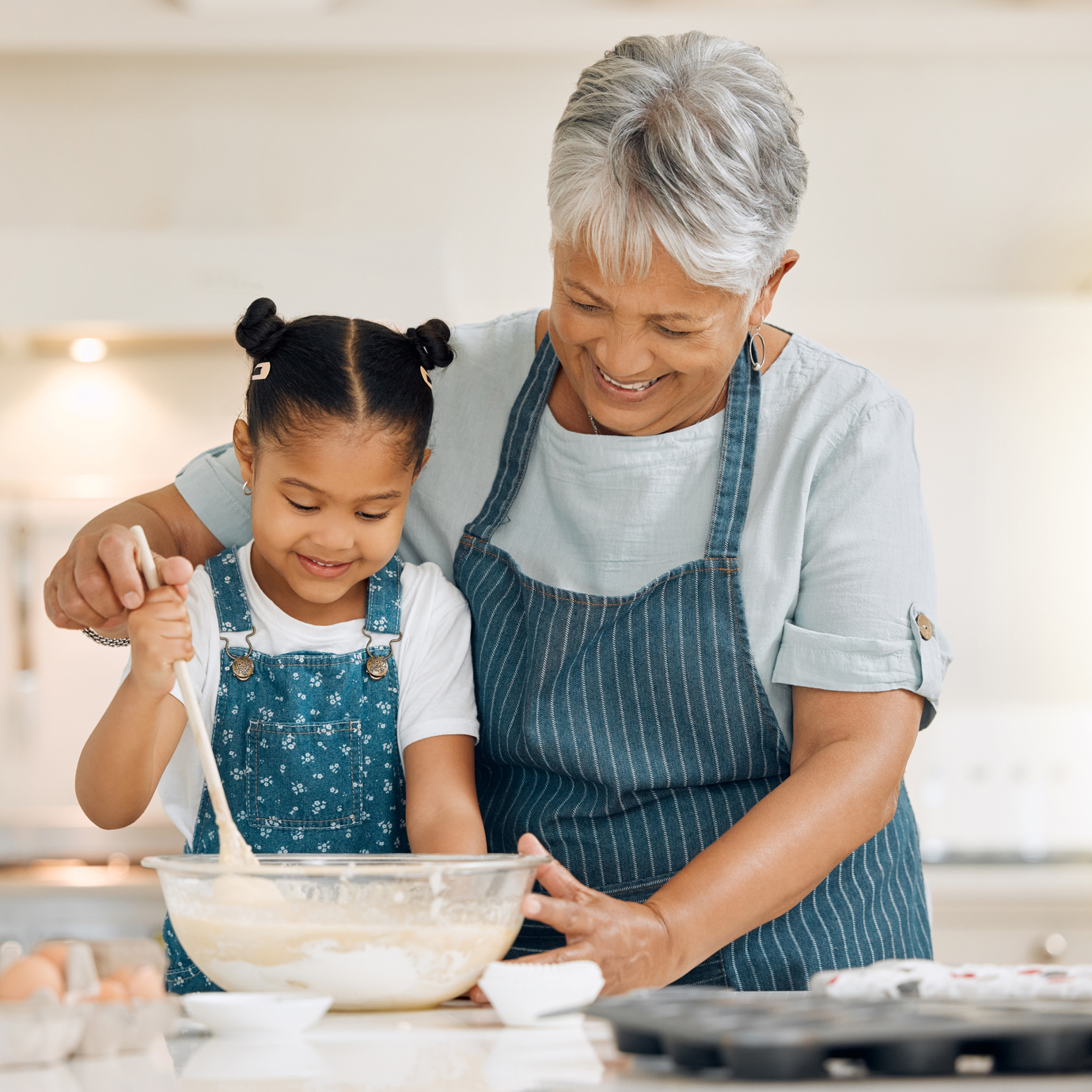 Grandma and granddaughter baking together 