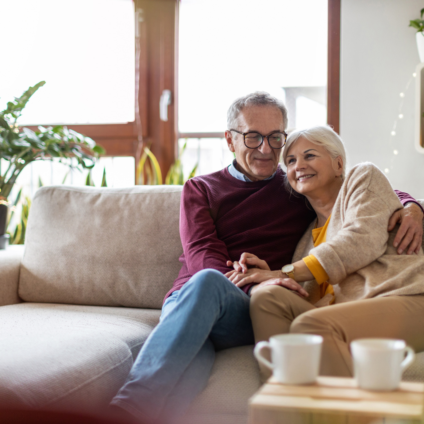 Older couple cuddling on the sofa